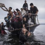 Nov. 16, 2015. Migrants arrive by a Turkish boat near the village of Skala, on the Greek island of Lesbos. The Turkish boat owner delivered about 150 people to the Greek coast and tried to escape back to Turkey; he was arrested in Turkish waters. Photo by Sergey Ponomarev for The New York Times